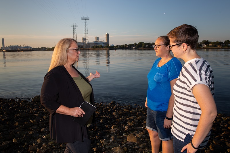 Elizabeth speaks to local residents about the local compressor station visible in background